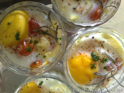 Baked eggs ready to be served, topped with cayenne pepper, black pepper and parsley Baked eggs ready to be served, topped with cayenne pepper, black pepper and parsley
