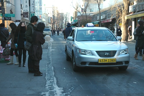 Big Taxi on a Narrow Lane on Insadong-gil. Big Taxi on a Narrow Lane on Insadong-gil.