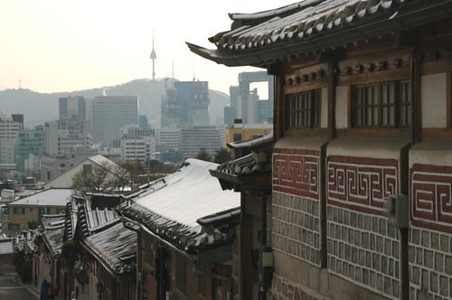 The black roofs of traditional Korean homes with Seoul Tower in the background. The black roofs of traditional Korean homes with Seoul Tower in the background.