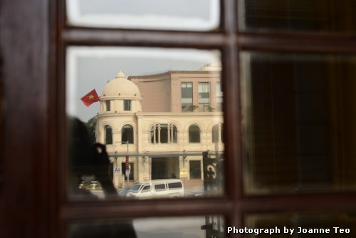 20130301-021742_JTJ_2457 Reflection of the Hanoi Stock Exchange in the Opera House door.