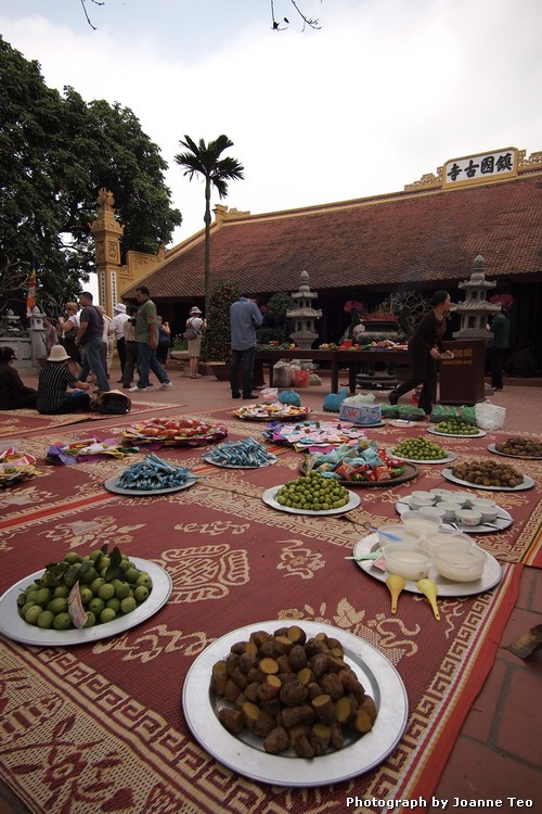 20130301-063432_P3012935 Food and money offerings at Tran Quoc Pagoda.