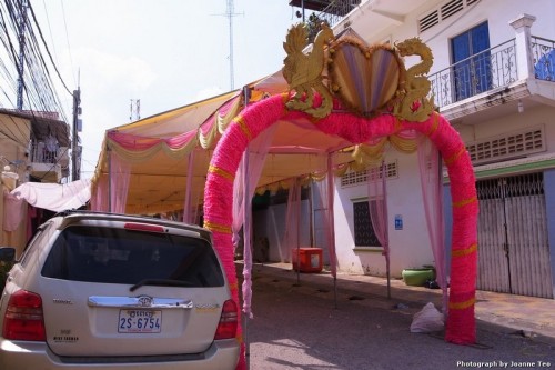 Tent goes up in middle of road for wedding.